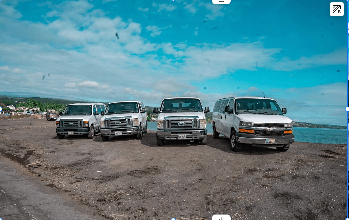Four Big Island Van Rentals vans lined up along the Hilo coastline, ready for delivery to ITO and KOA